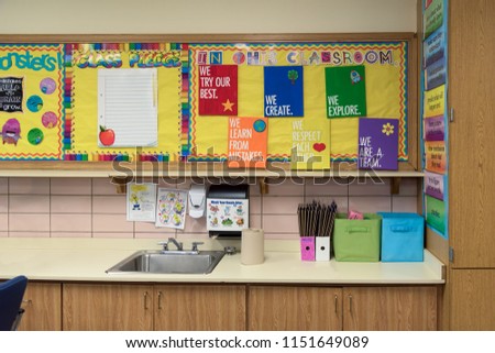 Bright and colorful bulletin boards above the sink in an elementary school classroom