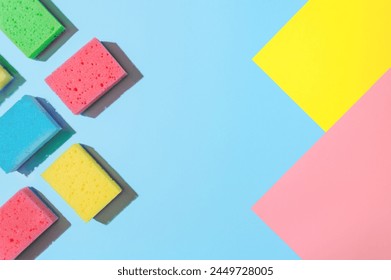 Bright and Colorful Cleaning Sponges: A Flat Lay for Cleaning Services or Housekeeping, copy space. Flat Lay of Cleaning Sponges: A Colorful, Bright and Eye-Catching Display for Cleaning Services.