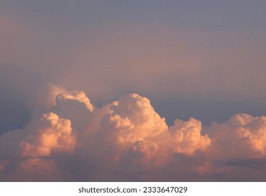 Bright colorful cumulus clouds on sunset sky. Background cloudscape wallpaper with copy space. - Shutterstock ID 2333647029
