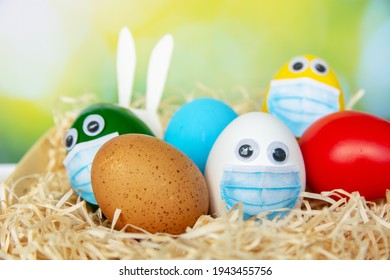 Bright Colorful Easter Eggs In Medical Face Mask Celebration Religious Holidays During  House Quarantine, Lockdown Concept Of Coronavirus Covid 19 Pandemic