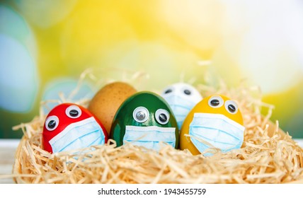 Bright Colorful Easter Eggs In Medical Face Mask Celebration Religious Holidays During  House Quarantine, Lockdown Concept Of Coronavirus Covid 19 Pandemic