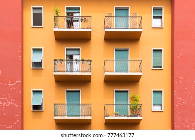 Bright colorful facade of old European building with Windows, balconies and flowers in Verona, Italy. Laconic minimalist concept - Powered by Shutterstock