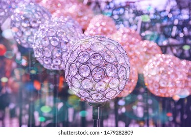 Bright colorful garden decoration, close up, bokeh background. Mosaic glass shiny bright ball on stick to decorate  garden, in garden shop. Deco Mosaic crystal Ball stylish garden decoration, closeup