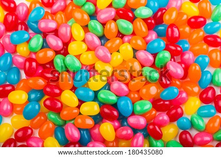 Bright, colorful jellybeans in red, green, pink, blue, yellow and orange colors.