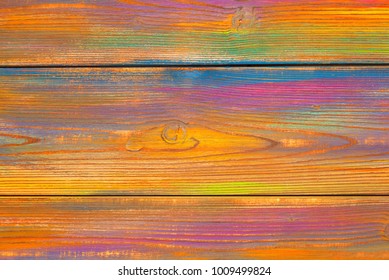 Bright, colorful mottled background. Wooden background painted colors. The texture of the wood. Blank background. Free space. background colored wood