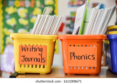 A Bright Colorful Photo Inside An Early Childhood Classroom, With A Focus On Two Baskets. One Says, 