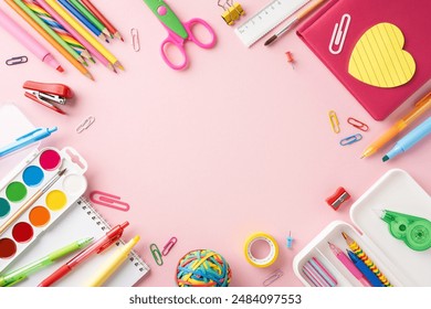 Bright and colorful school stationery arranged on a pink background, featuring pencils, markers, notebooks, and art supplies - Powered by Shutterstock