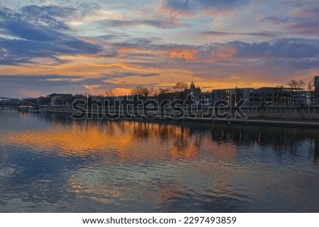 a bright colourful sunset over the Vistula River in Krakow, Poland. A city evening landscape
