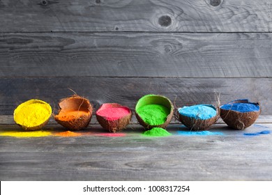 Bright colours in coconut shells for Indian holi festival. Colorful gulal (powder colors) for Happy Holi.