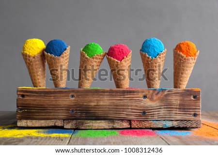 Bright colours in shapes of ice cream scoops in cones for Indian holi festival. Colorful gulal (powder colors) for Happy Holi.