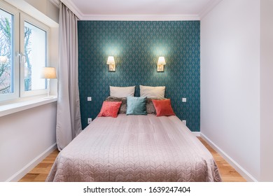 Bright and cozy elegant classic bedroom with elegant wallapaper and pillows on the bed