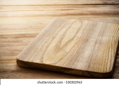 Bright cutting board on a background of the wooden table