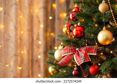 Bright decorated christmas tree. Close-up photo of a Christmas tree decorated with a bow, red and golden baubles with copy space. - Powered by Shutterstock