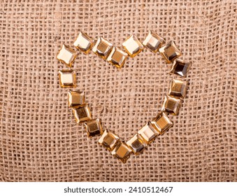 Bright decorative objects form a heart shaped  on canvas
