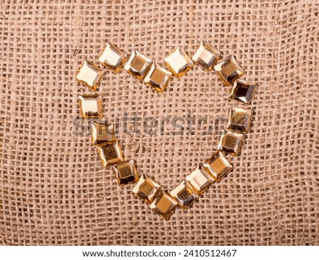 Bright decorative objects form a heart shaped  on canvas