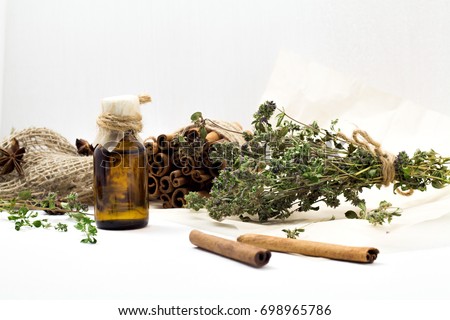 Bright dried medicinal herbs for cosmetic and healthcare use. Apothecary aroma dropper bottles. Natural herbal body balm