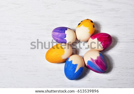 Bright Easter eggs in a colored basket. Testicles in a wooden box. The painted Easter eggs on a virgin background . color easter eggs