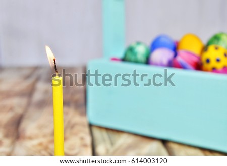 Bright Easter eggs in a colored basket. Testicles in a wooden box. The painted Easter eggs on a virgin background. color easter egg