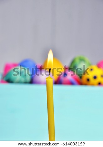 Bright Easter eggs in a colored basket. Testicles in a wooden box. The painted Easter eggs on a virgin background. color easter egg