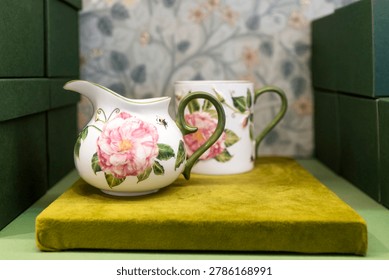 A bright elegant interior features a delicate glass vase filled with light purple fringed tulips reflecting beautifully on the surface of an antique round mirrored table in a vintage style room.