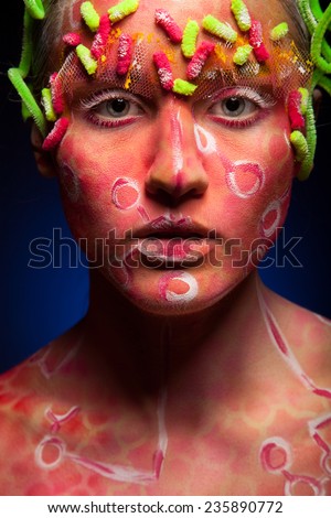 Bright face art and body art. Pretty woman portrait with paint on face. Creative make up