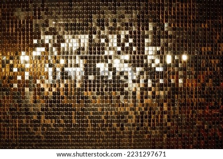 Bright falling confetti gold glitterins ribbons background glistening light twinkle for celebrating new year and christmas. Sparkling bokeh wonderful yellowish sequins garland sequin of shiny glitter