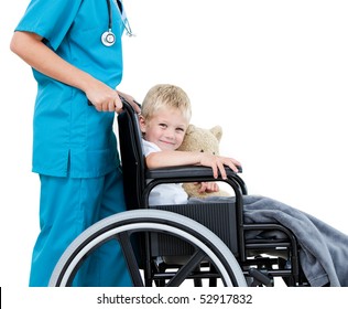 Bright female doctor carrying adorable little boy with his teddy bear in the wheelchair at the hospital - Powered by Shutterstock