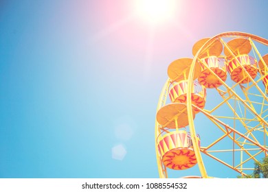 Bright Ferris wheel against the blue sky
