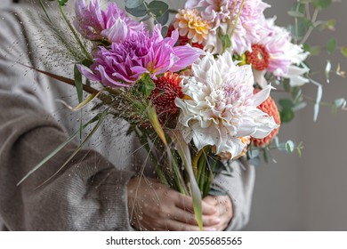 Bright festive bouquet with chrysathemum flowers in female hands, bright flower arrangement.