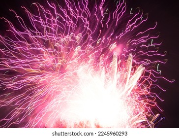 Bright fiery fireworks exploding in the sky