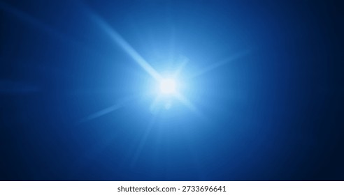 A bright flash of blue light creating a glare on a dark background, evoking a sense of mystery. Real optical lens flare on a black background, star glare.