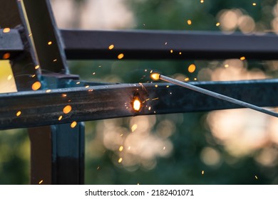 A Bright Flash Of An Electric Arc Between The Electrode And The Metal. Arc Welding