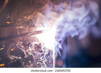 A Bright Flash Of An Electric Arc Between The Electrode And The Metal. Arc Welding