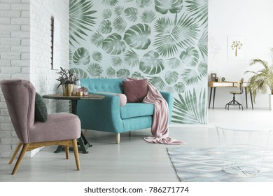 Bright flat with white brick wall and monstera leaves wallpaper in botanic living room - Shutterstock ID 786271774