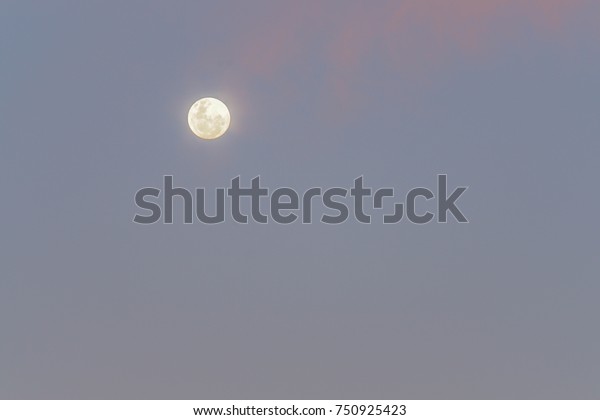 bright full moon in\
clear sky after sunset