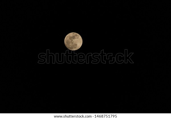 Bright full moon in the\
dark night sky