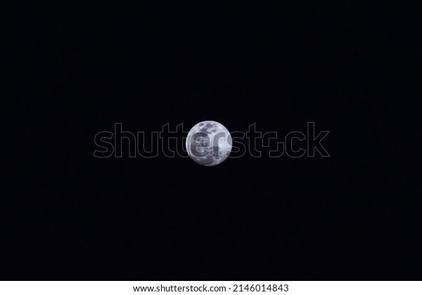 Bright full moon on a dark\
sky
