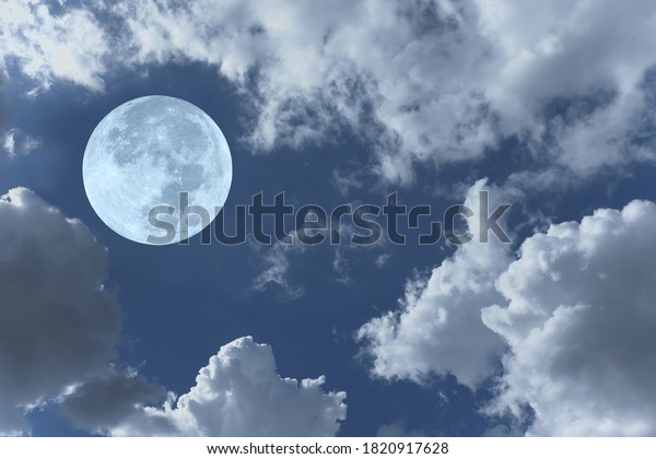 Bright full moon in the\
sky with clouds.