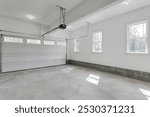 Bright Garage Space With Dual Overhead Doors Open.