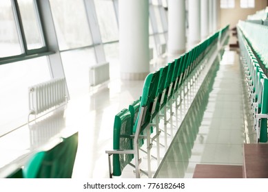 Bright glazed arena with green chairs and white ceramic flooring - Shutterstock ID 776182648