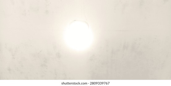 A bright, glowing light source radiates from a stark, minimalist background, creating a high-contrast and focused visual experience.