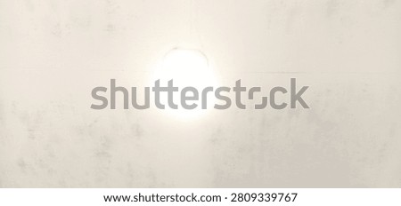 A bright, glowing light source radiates from a stark, minimalist background, creating a high-contrast and focused visual experience.