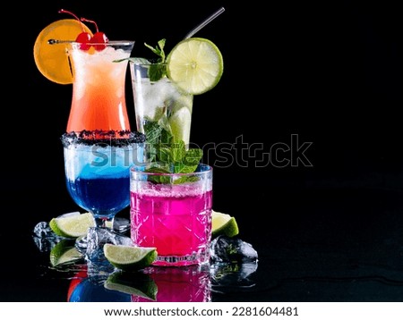 Bright glowing refreshing cocktails on reflective glass with copy space.