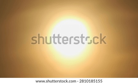 Bright glowing sun shining through a hazy, warm orange and sepia sky