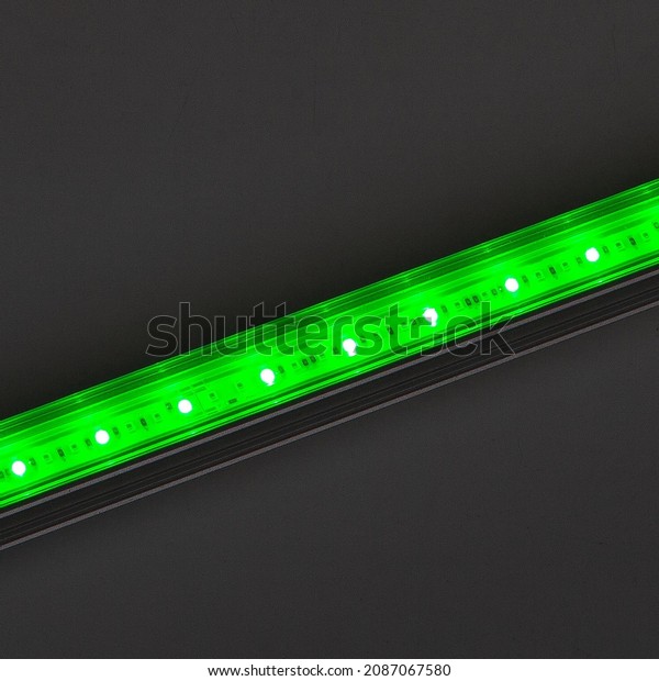 Bright
green LED flood light bar on black
background.