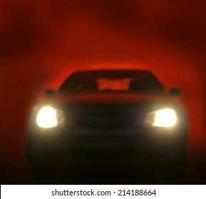 Bright Headlights On Car. Red Background 