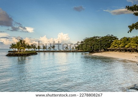 Bright heavenly tropical beach Upolu Island, Samoa in the Pacific Ocean, a small island with palm trees. Summer, picturesque cumulus clouds in the blue sky, heaven, sun, great vacation and travel.