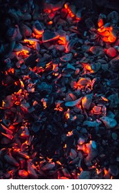 Bright Hot Coals And Burning Woods In Bbq Grill Pit. Glowing And Flaming Charcoal, Barbecue, Red Fire And Ash. Weekend Recreation Background. Close-up, Top View.