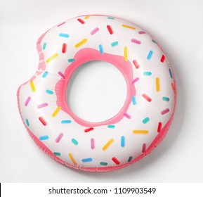 Bright inflatable donut on white background. Beach object