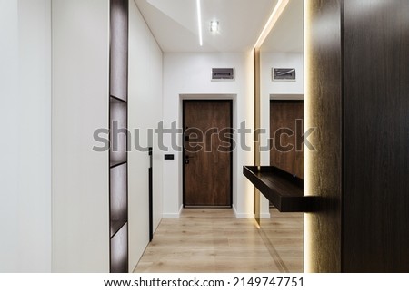 bright interior of the corridor with a mirror door and closet